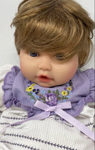 Load image into Gallery viewer, Paradise Galleries Brown Hair Blue Eyes Floral Outfit Sitting Reborn Baby Doll