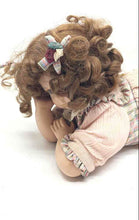 Load image into Gallery viewer, Brown Curly Hair And Blue Eyes Laying Down Girl Porcelain Doll In Pink Dress
