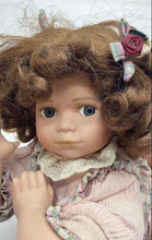 Load image into Gallery viewer, Brown Curly Hair And Blue Eyes Laying Down Girl Porcelain Doll In Pink Dress