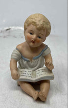 Load image into Gallery viewer, Vintage Bisque Porcelain Collectible Piano Baby Reading A Book Figurine