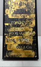 Load image into Gallery viewer, Decorative Framed Wall Art Print Of Stacked Designer Logos In Gold And Black
