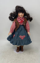 Load image into Gallery viewer, Black Curly Hair Blue Eyes Cowgirl Porcelain Doll In Multicolor Dress With Stand
