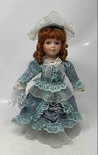 Load image into Gallery viewer, Vintage Collectible Brown Curly Hair Blue Eyes Porcelain Doll In Dress w/ Stand
