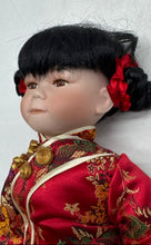 Load image into Gallery viewer, Black Hair Brown Eyes Porcelain Doll Collectible With Traditional Outfit
