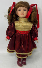 Load image into Gallery viewer, Collectors Choice Brown Hair Collectible Porcelain Doll In Red &amp; Gold Outfit
