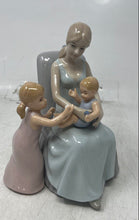 Load image into Gallery viewer, Vintage Porcelain Mother Sitting On A Chair With Her Two Young Children Figurine
