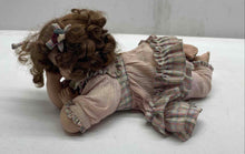 Load image into Gallery viewer, Brown Curly Hair And Blue Eyes Laying Down Girl Porcelain Doll In Pink Dress
